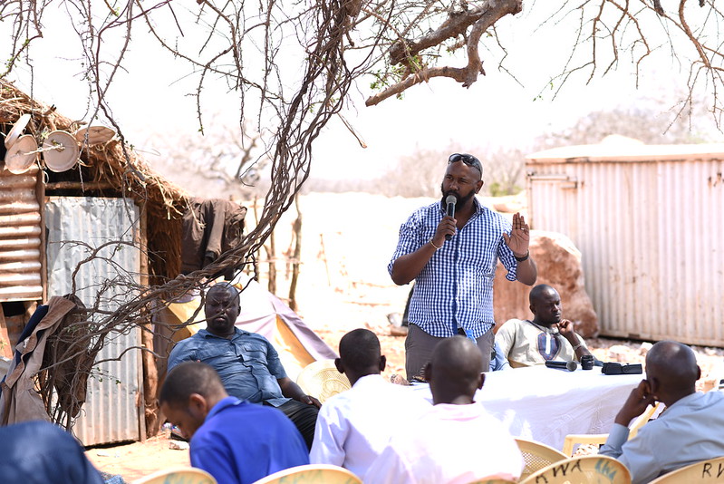 Jonah speaking at a meeting with ASMs in Kasighau, Taita Taveta County